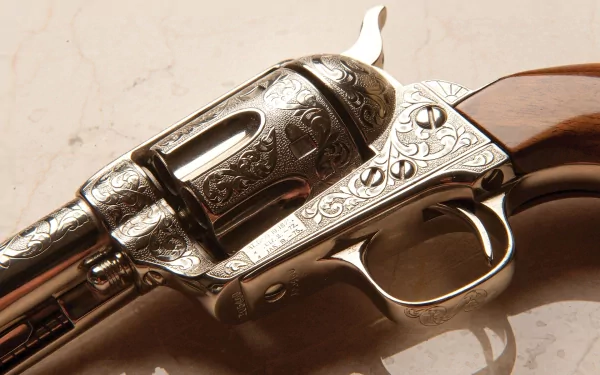 Close-up of a detailed, engraved man-made revolver captured in HD for a desktop wallpaper and background.