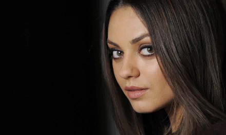 A high-definition desktop wallpaper featuring a close-up of American actress Mila Kunis, showcasing her brunette hair and captivating expression.