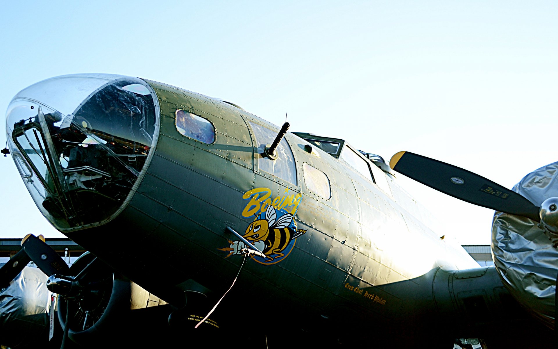 Close-up view of a vintage military aircraft with detailed nose art, captured in 4K Ultra HD for a sharp PC desktop wallpaper and background.