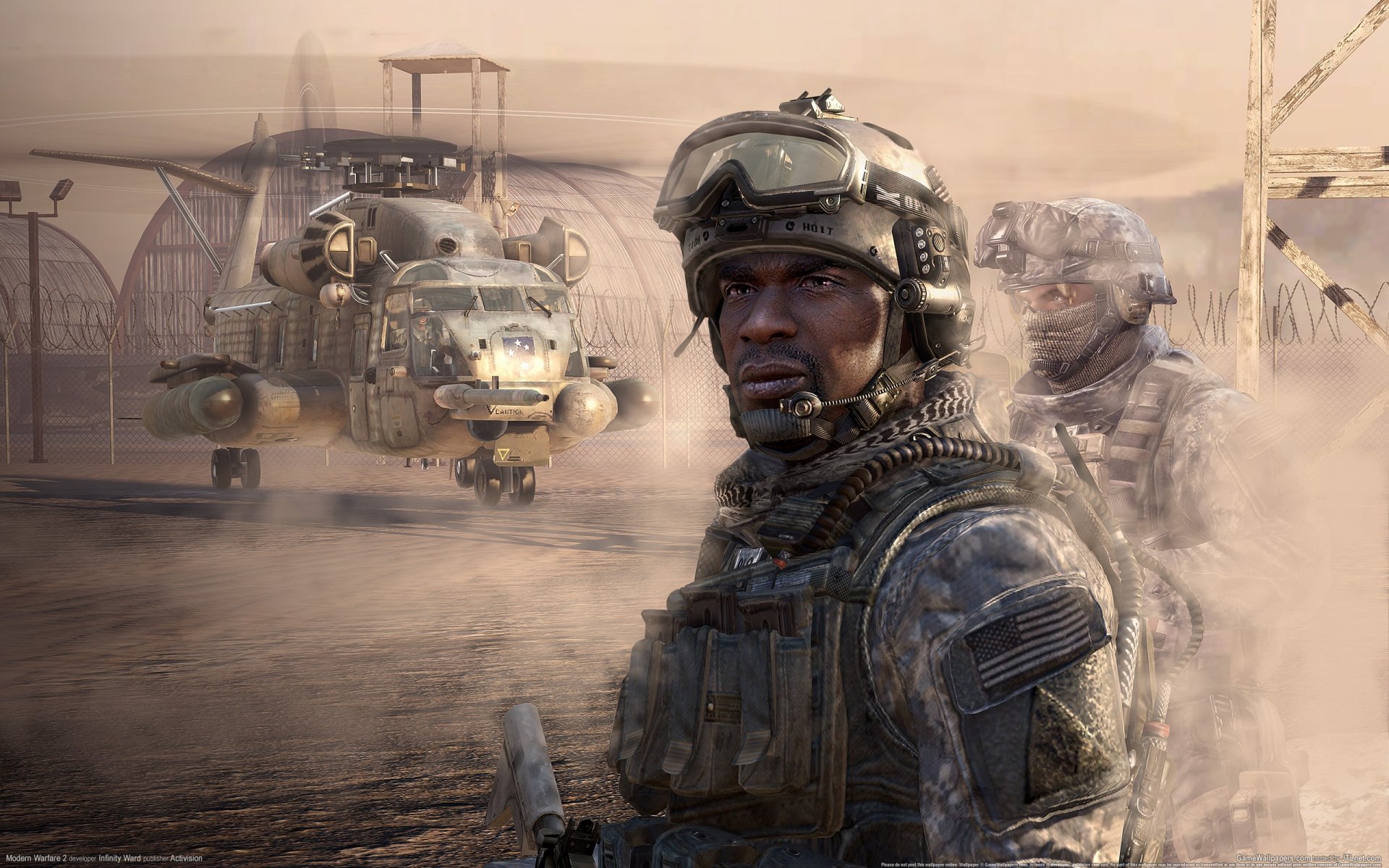 Call of Duty: Modern Warfare 2 2K Quad HD PC wallpaper — armed soldier in modern combat gear stands in a dusty desert airbase with transport helicopters and hangars looming behind him.