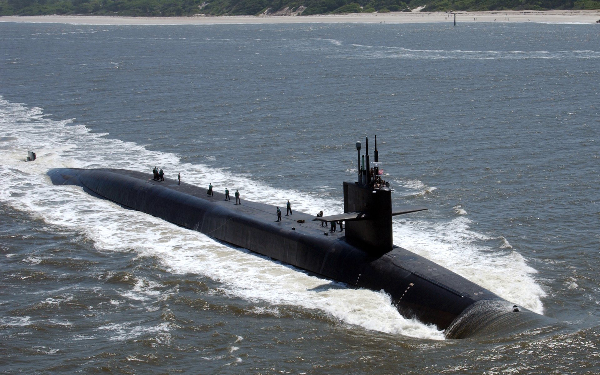 A military submarine cutting through the ocean waves, showcased as a high-definition PC desktop wallpaper and background.