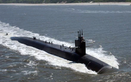 A military submarine cutting through the ocean waves, showcased as a high-definition PC desktop wallpaper and background.