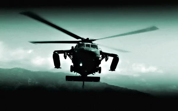 Military Sikorsky UH-60 Black Hawk helicopter silhouetted over mountains in moody teal tones — HD PC desktop wallpaper/background.
