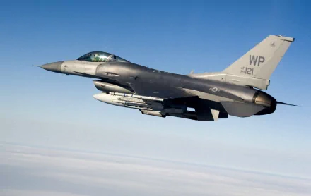 HD image of a United States Air Force General Dynamics F-16 Fighting Falcon in flight against a clear blue sky.