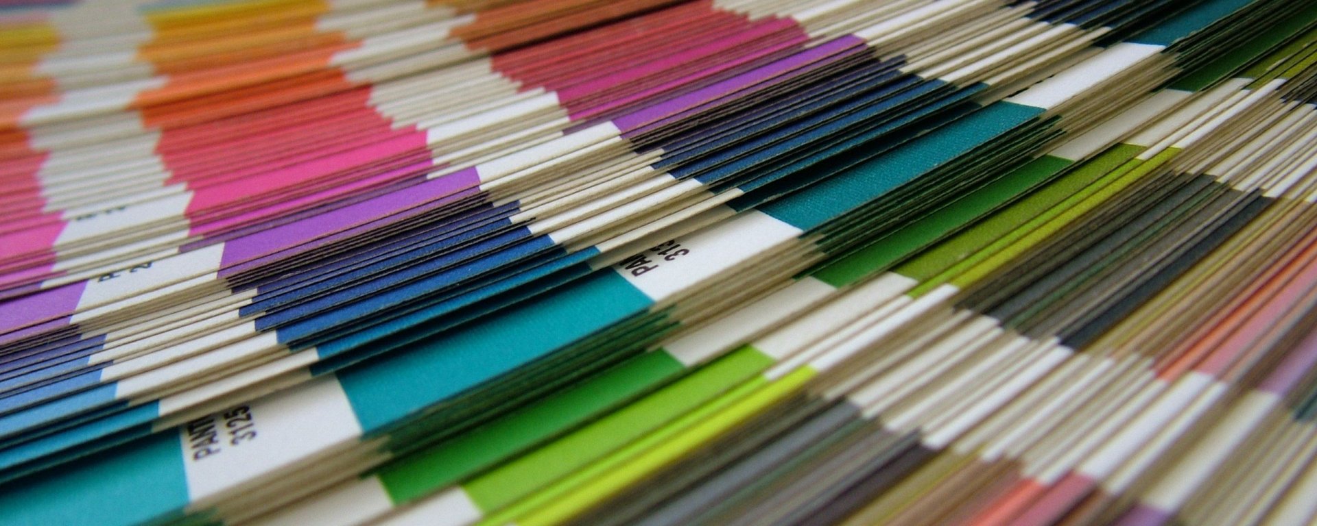 Artistic HD PC desktop wallpaper featuring close-up vibrant color swatches arranged in diagonal rows, showcasing a spectrum of hues and textures.