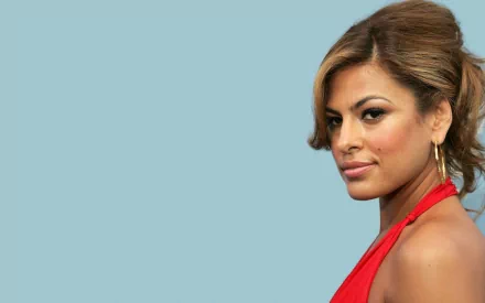 HD desktop wallpaper featuring celebrity Eva Mendes against a solid light blue background, showcasing her in a red outfit with styled hair and hoop earrings.