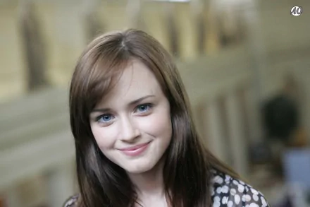 A high-definition desktop wallpaper featuring Alexis Bledel, showcasing her warm smile and captivating blue eyes against a softly blurred background.
