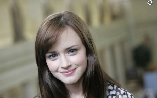 A high-definition desktop wallpaper featuring Alexis Bledel, showcasing her warm smile and captivating blue eyes against a softly blurred background.