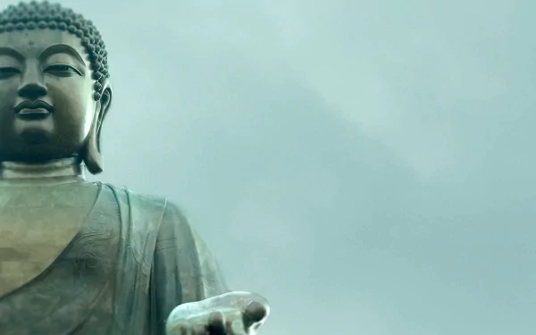 HD desktop wallpaper featuring a serene statue of Buddha against a calming, cloudy sky; a beautiful representation of religious Buddhism.