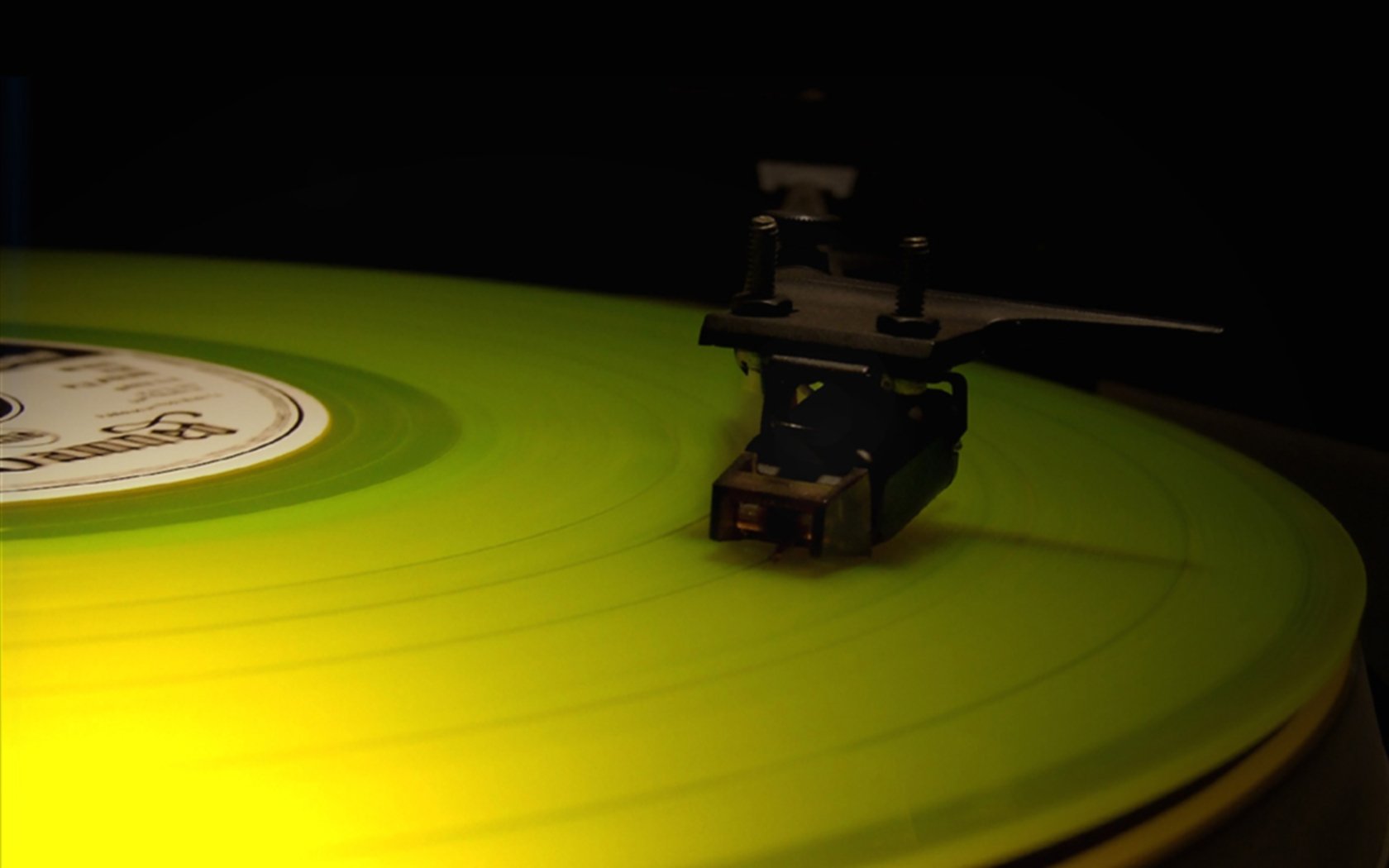 Close-up of a green vinyl record on a turntable, highlighting the DJ's needle in action, captured as an HD desktop wallpaper background.