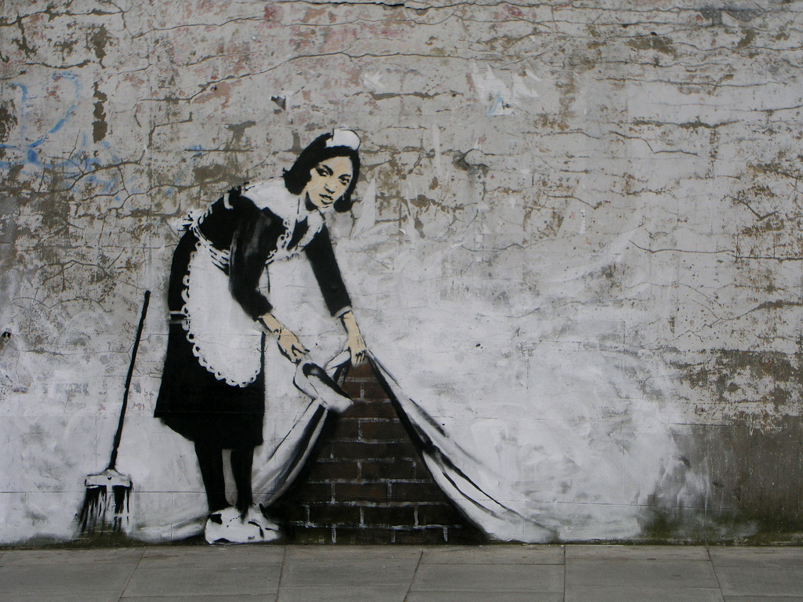 Stylish maid holding a broom, artwork by Banksy.