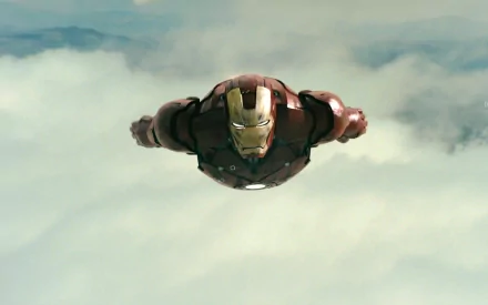 HD desktop wallpaper featuring Tony Stark as Iron Man flying above clouds from the movie Iron Man.