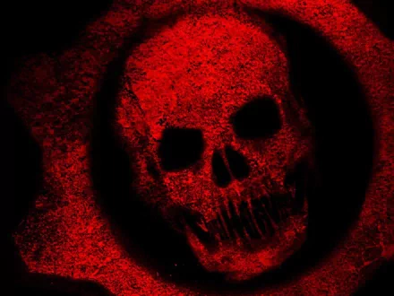 HD desktop wallpaper for the video game Gears of War, featuring a red, grunge-textured skull emblem.