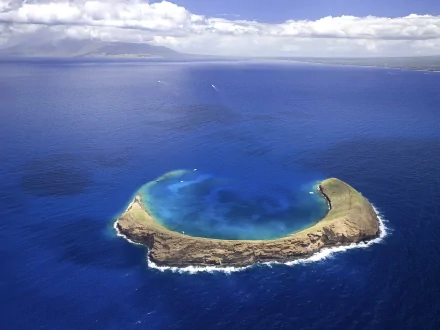 A stunning aerial view of a serene island surrounded by deep blue waters, showcasing the beauty of nature in this high-definition desktop wallpaper.