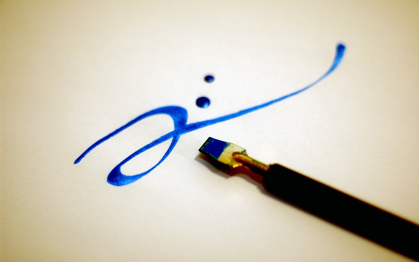 An artistic blue ink drawing featuring elegant strokes and dots, accompanied by a calligraphy pen, serves as an inspiring HD PC desktop wallpaper and background.