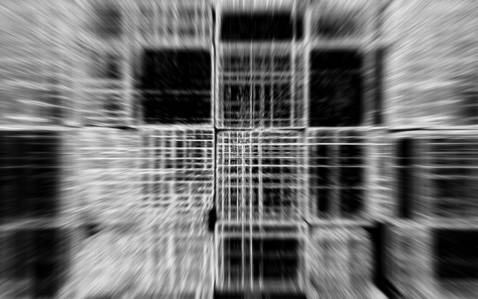 An abstract HD wallpaper featuring a blurred cube pattern in shades of black and white, creating a dynamic and modern background for your desktop.