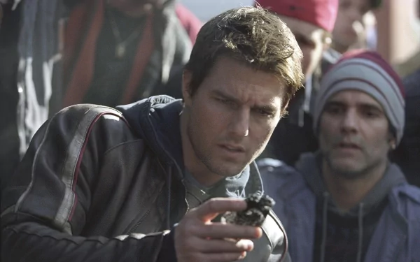 HD PC desktop wallpaper from the movie War of the Worlds, featuring a tense close-up of a man holding a small object with people blurred in the background.