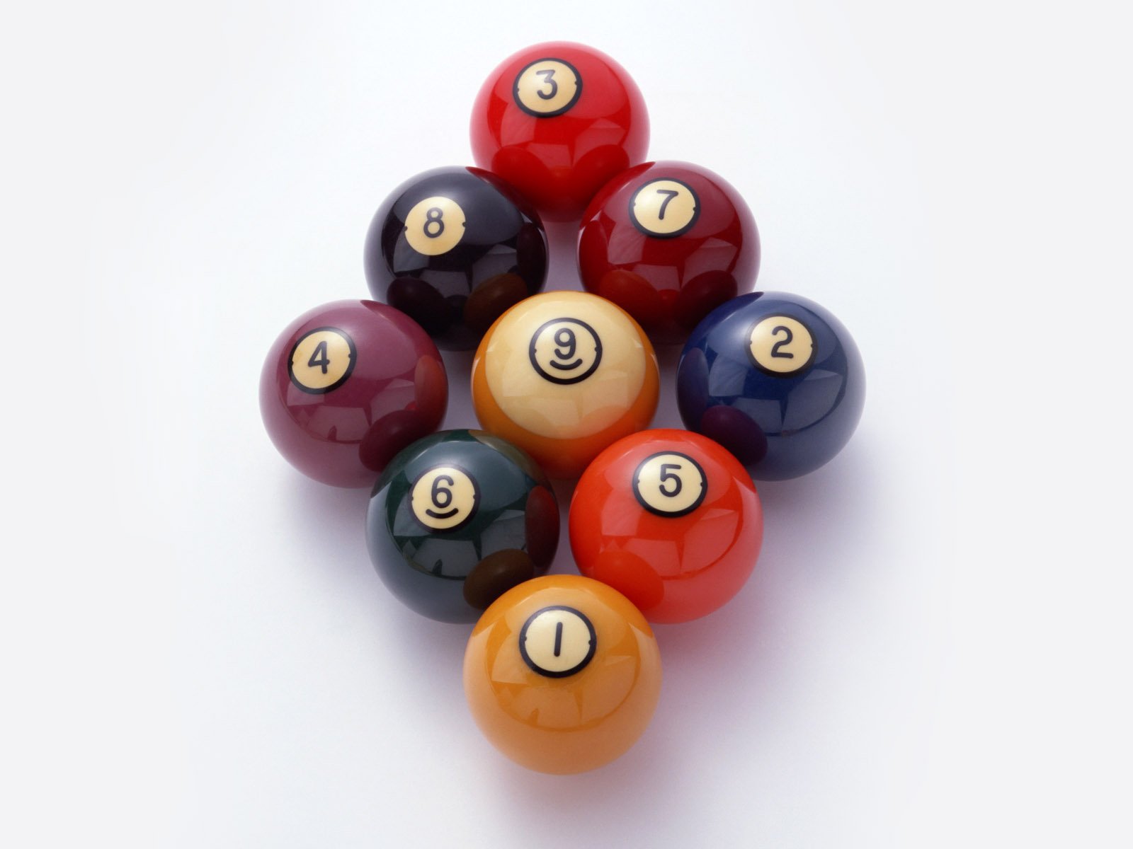 A high-definition wallpaper featuring a grouping of pool game balls, arranged with numbers visible. The vibrant colors of the balls stand out against a clean background.
