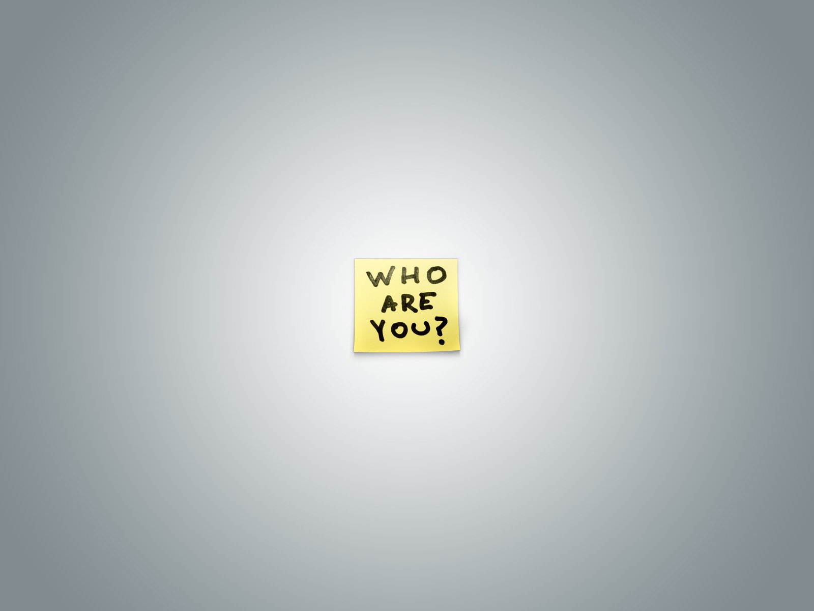 A minimalistic HD desktop wallpaper featuring a yellow sticky note with the text WHO ARE YOU? against a light grey background, conveying a funny and quirky vibe.