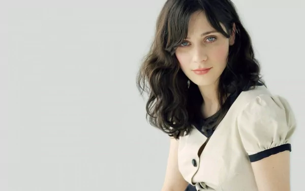 A high-definition desktop wallpaper featuring Zooey Deschanel, showcasing her captivating expression and unique style against a soft background.