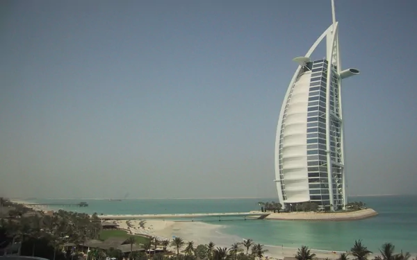 HD desktop wallpaper featuring the iconic man-made Burj Al Arab hotel in Dubai against a clear sky and calm sea backdrop.