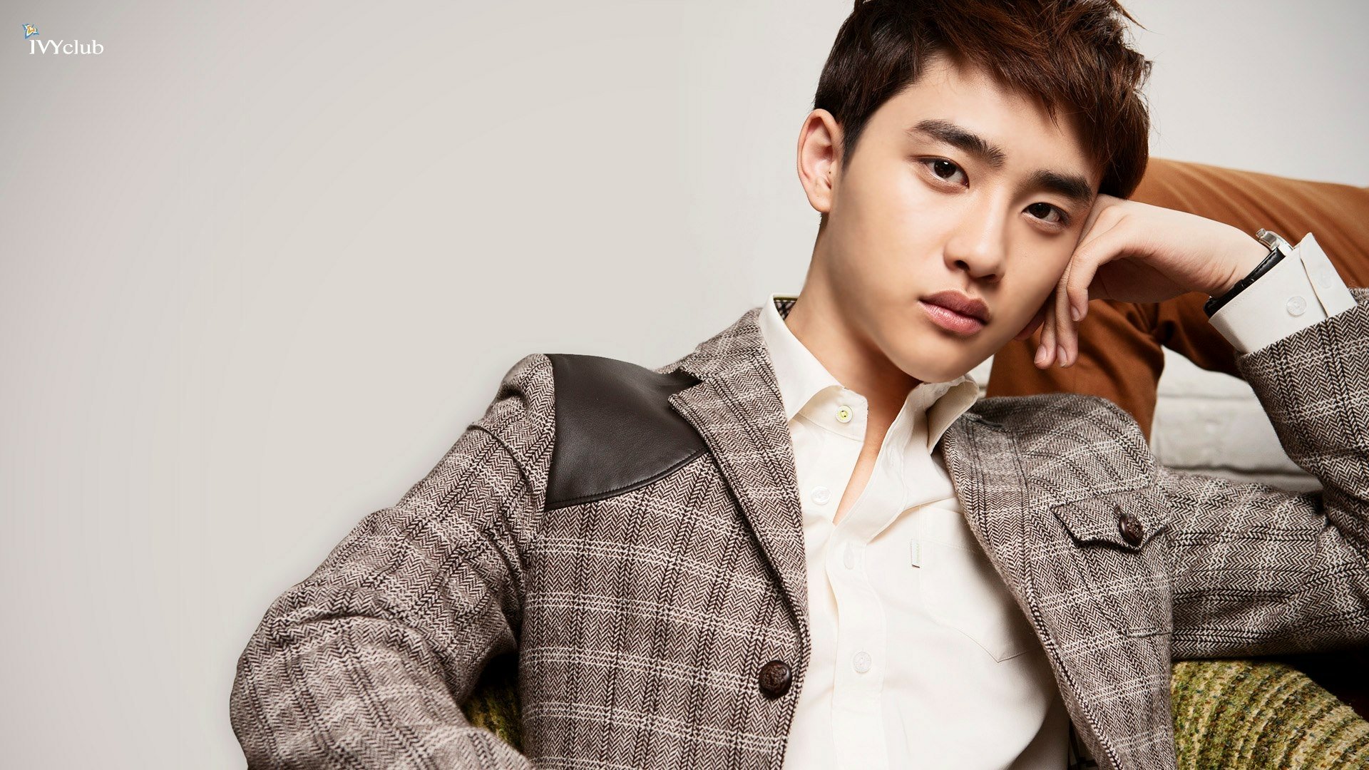 HD PC desktop wallpaper featuring a member of EXO in a stylish checkered blazer, embodying music and modern fashion.