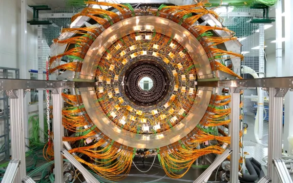 HD desktop wallpaper showcasing the intricate, man-made Large Hadron Collider with detailed wiring and circular metallic structure in a high-tech facility.