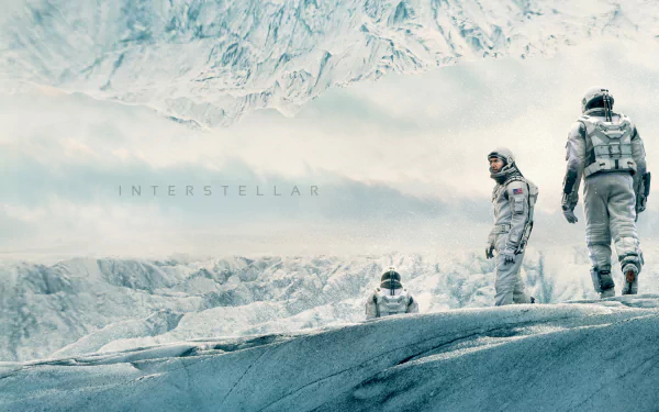 HD desktop wallpaper from the movie Interstellar featuring astronauts walking on a frosty, alien landscape with mountains in the background.