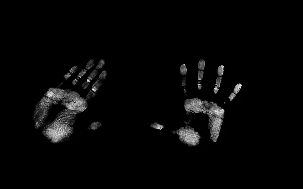 Artistic handprints in stark contrast against a black background create a striking visual. This HD wallpaper serves as a unique desktop background, showcasing creative expression.