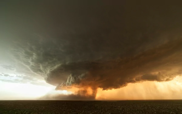 HD desktop wallpaper capturing a powerful tornado under a dark stormy sky, showcasing the raw intensity of nature.