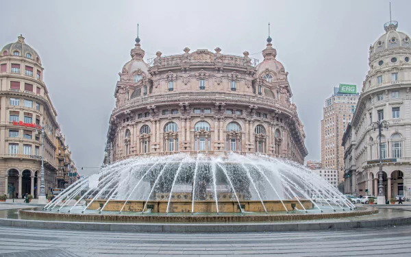 HD desktop wallpaper showing a grand man-made fountain and historic buildings in Genoa under an overcast sky.