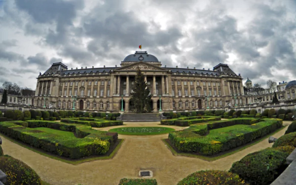 HD desktop wallpaper showcasing the Royal Palace of Brussels with its manicured gardens under a cloudy sky, highlighting this man-made architectural landmark.