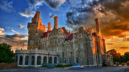HD PC desktop wallpaper/background — Casa Loma, a man-made stone castle lit by golden sunset under dramatic clouds.