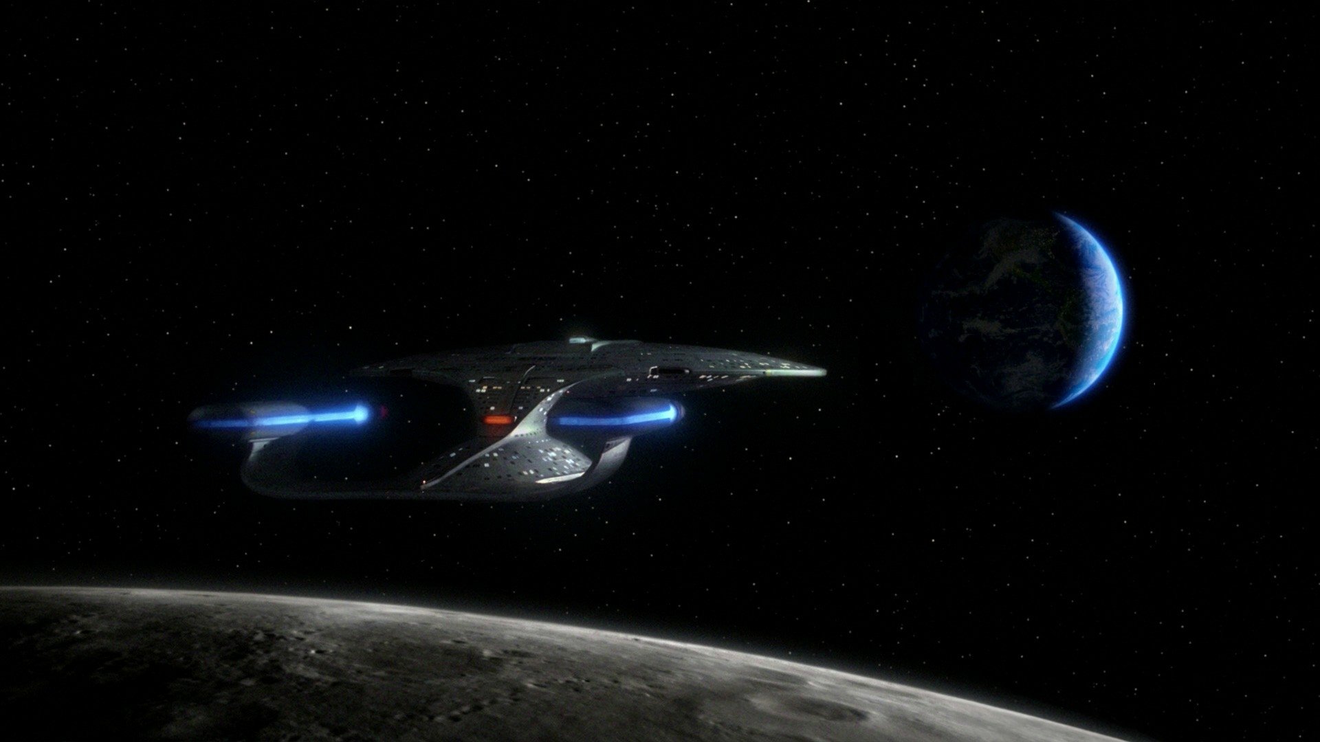 A sleek starship glides through space, illuminated by blue lighting, with a distant Earth visible nearby. This HD sci-fi wallpaper captures the essence of Star Trek's adventurous spirit.
