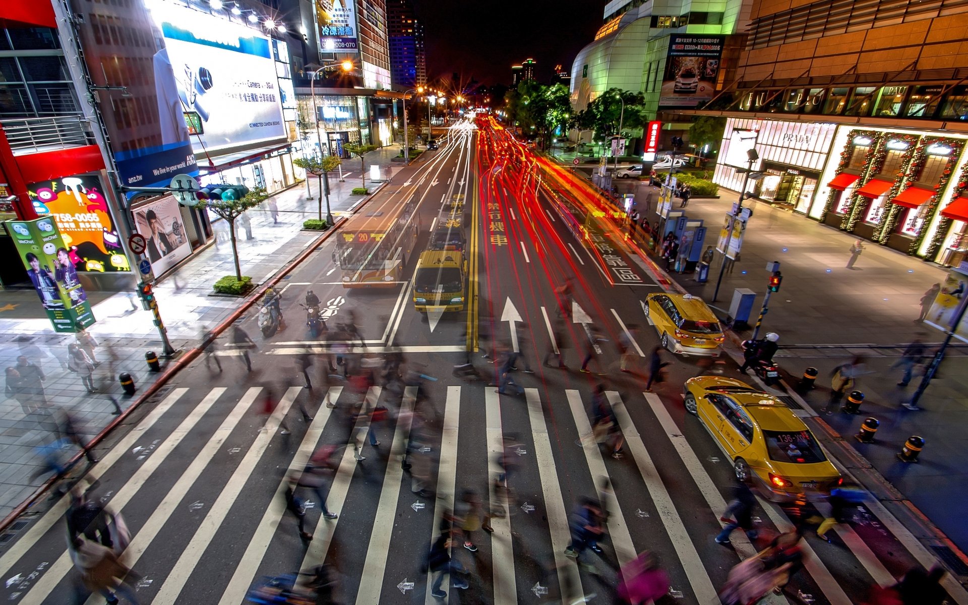 A vibrant night scene of a busy Taipei street with light trails from vehicles, captured in 4K Ultra HD as a striking man-made urban landscape.