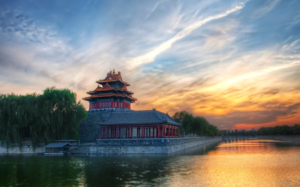 4K Ultra HD image of the Forbidden City in Beijing, China, showcasing traditional man-made architecture by a serene waterside at sunset.