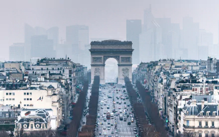A stunning HD wallpaper featuring the iconic Arc de Triomphe in Paris, framed by bustling streets and a backdrop of modern skyscrapers, capturing the essence of the city's blend of history and progress.
