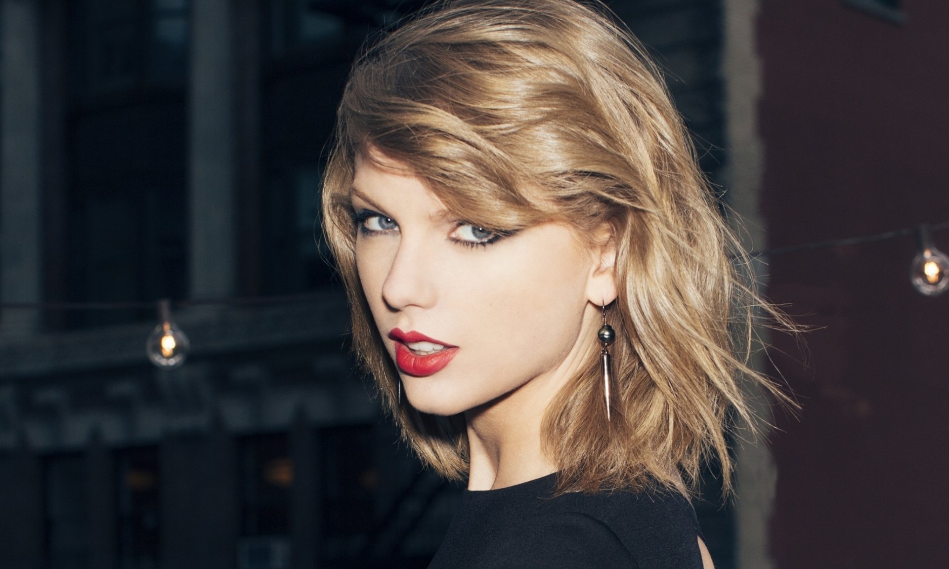 HD desktop wallpaper featuring Taylor Swift with striking makeup and a stylish haircut, capturing the essence of her music and personality.