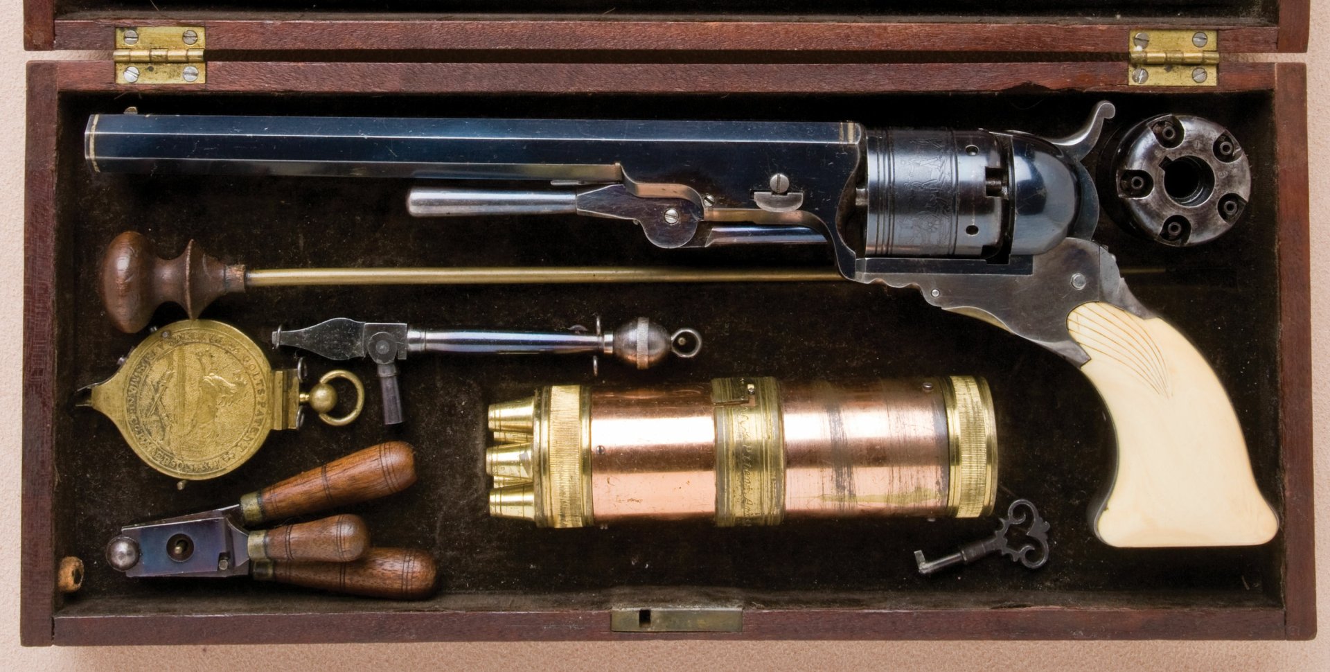 HD desktop wallpaper featuring a detailed close-up of a man-made Colt revolver and its accessories neatly arranged in a wooden case.