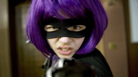 Close-up of Hit-Girl from the movie Kick-Ass, portrayed by Chloë Grace Moretz, with purple hair and a black mask, captured in 4K Ultra HD for a PC desktop wallpaper.