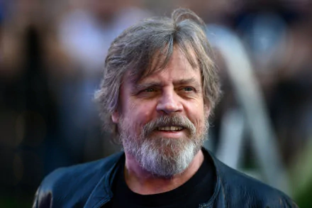HD desktop wallpaper featuring a smiling person with a beard and dark shirt, providing a charismatic background.