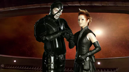 HD PC desktop wallpaper featuring characters from the TV show Farscape, showcasing two futuristic figures in dark, stylized costumes against a space-themed background.