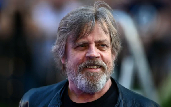 HD desktop wallpaper featuring a smiling person with a beard and dark shirt, providing a charismatic background.