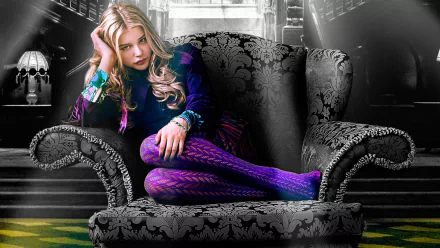 HD desktop wallpaper featuring Chloë Grace Moretz from the movie Dark Shadows, lounging on an ornate, dark patterned chair.
