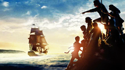 HD PC desktop wallpaper from the movie The Goonies: silhouetted kids on a rocky shore pointing toward a tall sailing ship on the ocean at sunset.