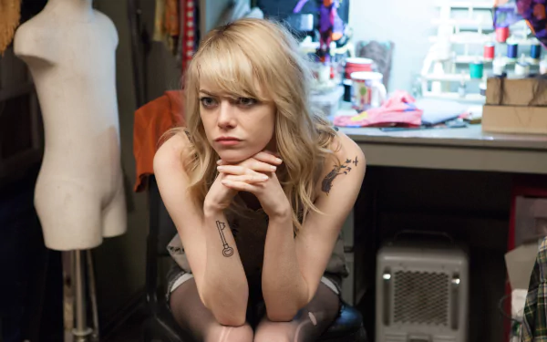 Pensive young woman seated in a cluttered dressing room; 2K Quad HD PC desktop wallpaper inspired by the movie Birdman.