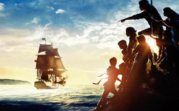 HD PC desktop wallpaper from the movie The Goonies: silhouetted kids on a rocky shore pointing toward a tall sailing ship on the ocean at sunset.