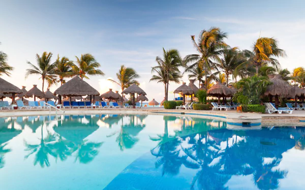 A tranquil resort scene featuring palm trees reflecting in a crystal-clear pool, capturing the essence of a tropical holiday in stunning 4K Ultra HD.