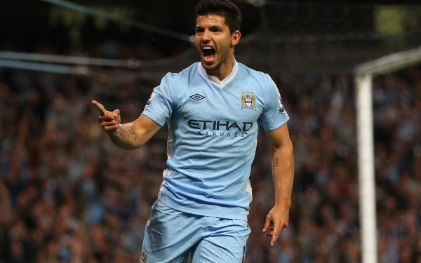 Sergio Agüero celebrates a goal wearing Manchester City F.C.'s light blue kit in this HD sports desktop wallpaper.