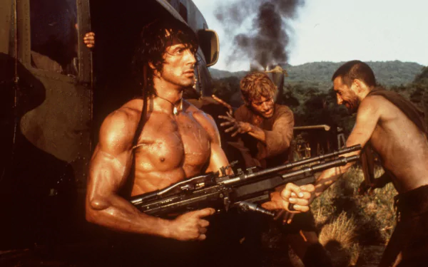 HD wallpaper featuring a scene from Rambo: First Blood Part II, showcasing an intense moment with the iconic character holding a weapon amidst fellow soldiers.